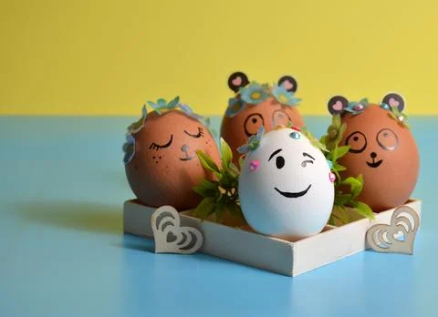 Easter eggs in a box on a yellow-blue background. Easter. Stock Photos