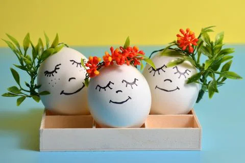 Easter eggs in a box on a yellow-blue background. Easter. Stock Photos