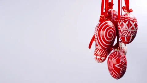 Easter eggs bunch with white on red folk pattern, hang on red ribbons Video stock 127888290