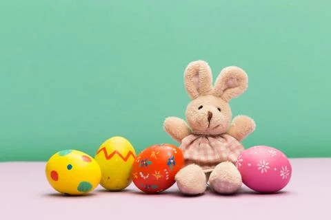 Easter eggs with bunny on colour background Foto stock