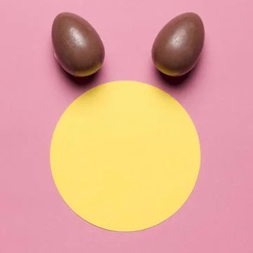 Easter eggs like bunny ear s round paper blank frame against pink backdrop Stock Photos