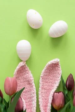 Easter Eggs with Bunny Ears and Tulips on Green Background. Spring Holiday .. Stock Photos