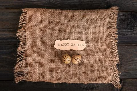 Easter eggs on burlap. happy Easter inscription Stock Photos