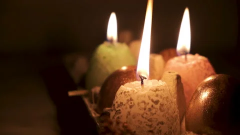 Easter eggs with candles. Burning candles in darkness. Stock Footage 146297870
