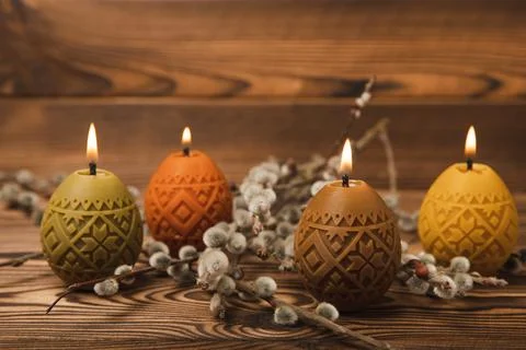 Easter eggs candles on a white texture background Stock Photos
