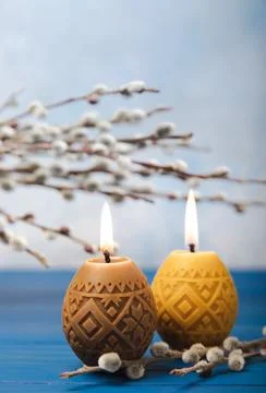 Easter eggs candles on a white texture background Stock Photos