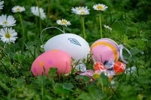 Easter eggs with candy in grass celebrating spring Stock Photos