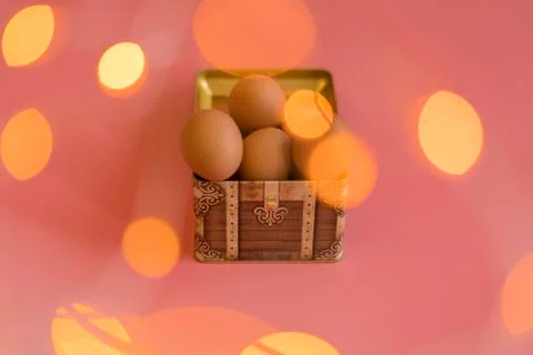 Easter eggs in a chest on a pink background. bokeh Stock Photos