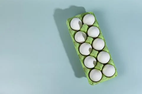 Easter eggs. Chicken white eggs on green background. Stock Photos