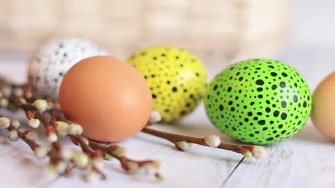 Easter eggs close-up on a wooden table and willow twigs. Painted Easter eggs Stock Footage 237820271