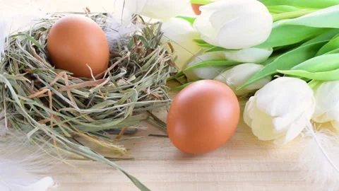 Easter eggs color in basket with spring tulips, white feathers Stock Footage 172084473