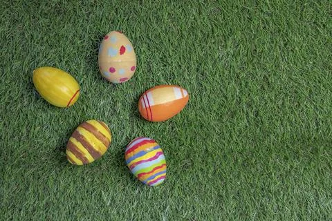 Easter eggs colored on grass top view or flat Stock Photos