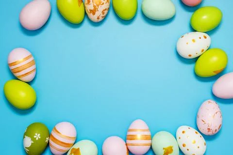 Easter Eggs. Colorful Easter eggs on blue background with copy space. Stock Photos