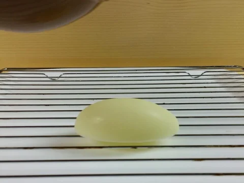 Easter eggs covered with melted chocolate - Slow motion Stock Footage 74464436