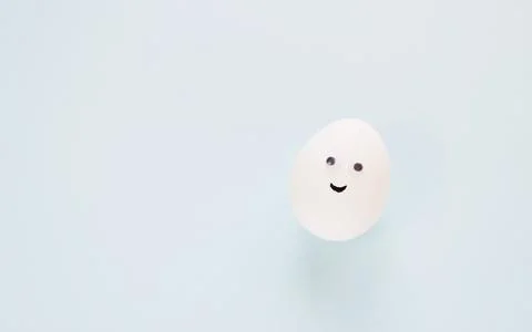 Easter eggs creative flat lay on blue background. Minimal concept. Stock Photos