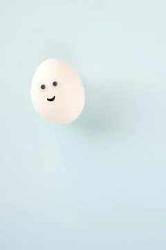 Easter eggs creative flat lay on blue background. Minimal concept. Stock Photos