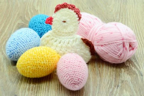 Easter eggs crochet of wool and chicken on wooden background Stock Photos