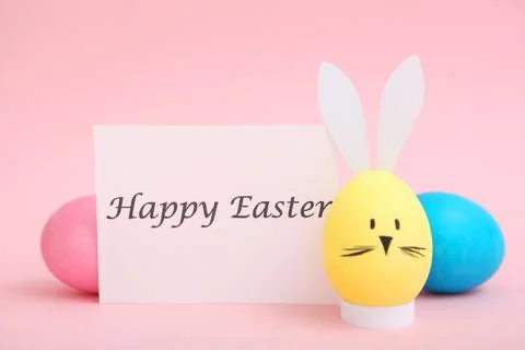 Easter eggs with cute faces and ears on a colored background. Stock-Fotos