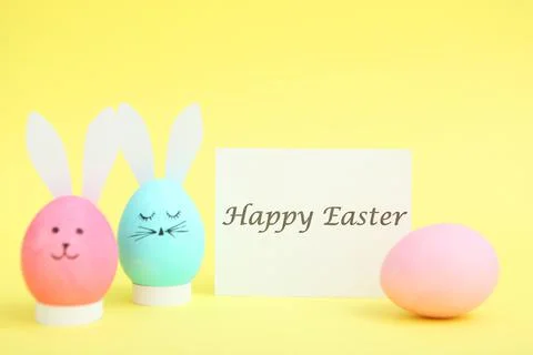 Easter eggs with cute faces and ears on a colored background. Stock-Fotos