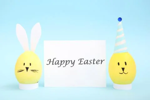 Easter eggs with cute faces and ears on a colored background. Stock Photos