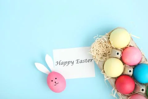 Easter eggs with cute faces and ears on a colored background. Fotos de archivo