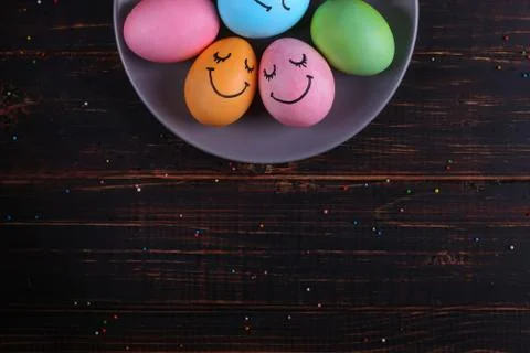 Easter eggs with cute faces on the plate. Preparing for the holiday on the ki Stock Photos