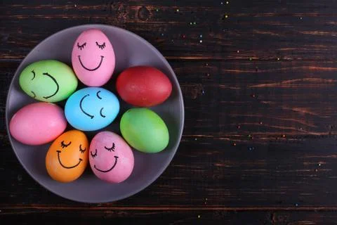 Easter eggs with cute faces on the plate. Preparing for the holiday on the ki Stock Photos