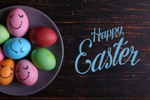 Easter eggs with cute faces on the plate. Preparing for the holiday on the ki Stock Photos
