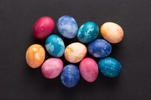 Easter eggs on dark stone background, top view 写真素材
