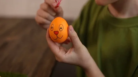 Easter eggs decorated, in the background child paint the egg Stock Footage
