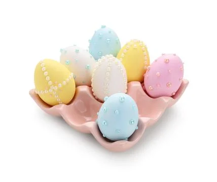 Easter eggs decorated with pearls in ceramic holder isolated on white backgro Stock Photos