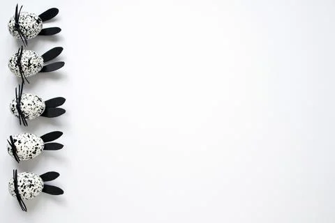 Easter eggs decorated as spotted black and white bunnies on the white background Stock Photos