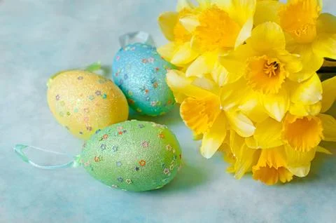 Easter eggs decorated with yellow daffodil flowers Stock Photos