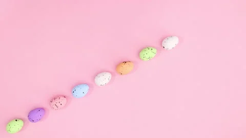 Easter eggs in different colors appear in one line. Stop motion Stock Footage 147740300