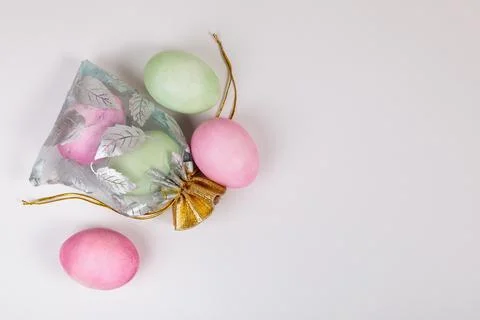 Easter. Eggs of different colors in a bag on a uniform blue background Stock Photos