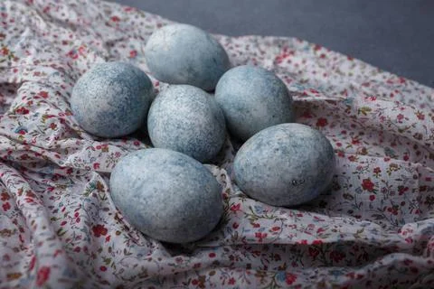 Easter eggs DIY painted blue on grey wooden background with kitchen towel Stock Photos