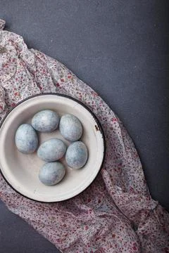 Easter eggs DIY painted blue in white bowl on grey wooden background Stock Photos