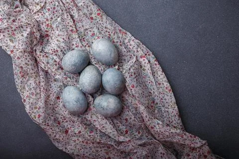 Easter eggs DIY painted blue on grey wooden background with kitchen towel Stock Photos