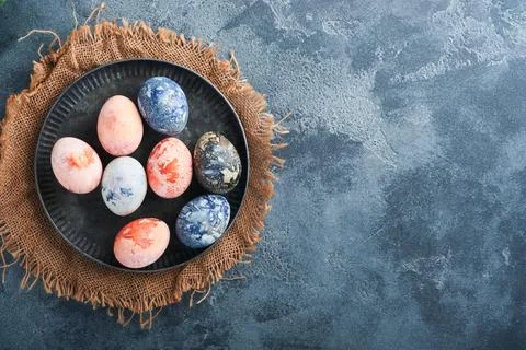 Easter eggs. Dyed Easter eggs with marble stone effect ref and blue color in  Stock Photos