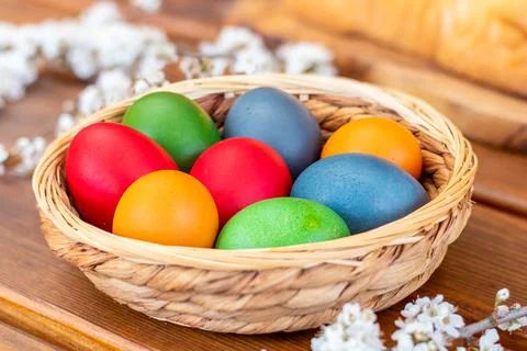Easter eggs, dyed hen eggs in a wicker basket bowl Stock Photos