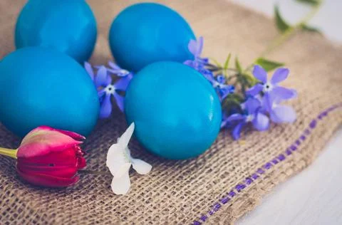Easter eggs with Easter and flowers close-up. Stock Photos