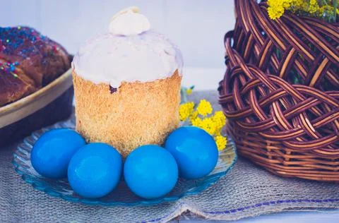 Easter eggs with Easter, flowers and a wicker basket Stock Photos