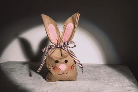 Easter eggs in an eco-friendly craft linen bag on a grunge grey background with Stock Photos