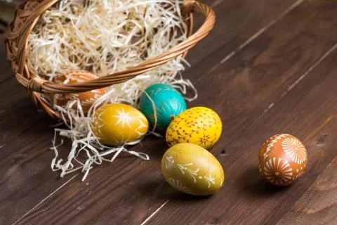 Easter eggs falling out from brown basket Stock Photos