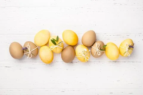 Easter eggs with flowers on a white table. Stock Photos