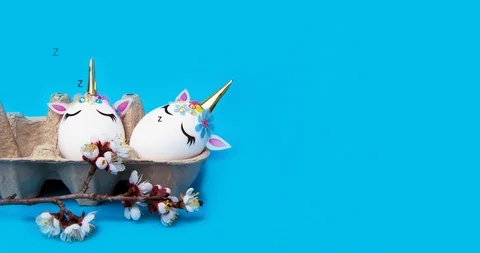 Easter eggs in the form of unicorns lie and sleep in a box. Stock Footage 127038596