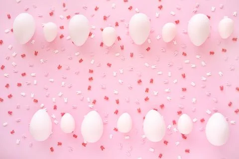 Easter eggs frame with bunny ears sugar sprinkle on pink background. Egg hunting Stock Photos