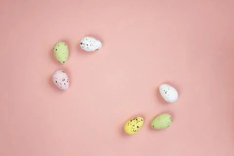 Easter eggs frame on a pink background. Copy space. Minimalist composition. Stock Photos