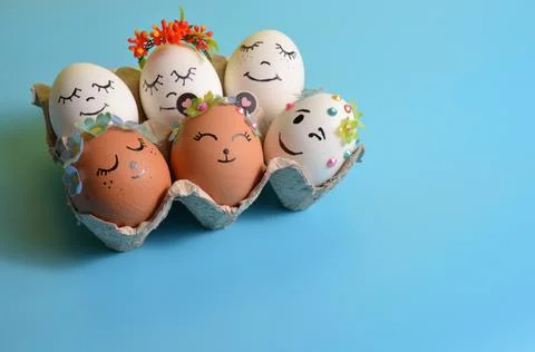 Easter eggs with funny faces on a blue background. Spring. Easter. Stock Photos