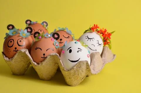 Easter eggs with funny faces in an egg container. Spring. Easter. Stock Photos